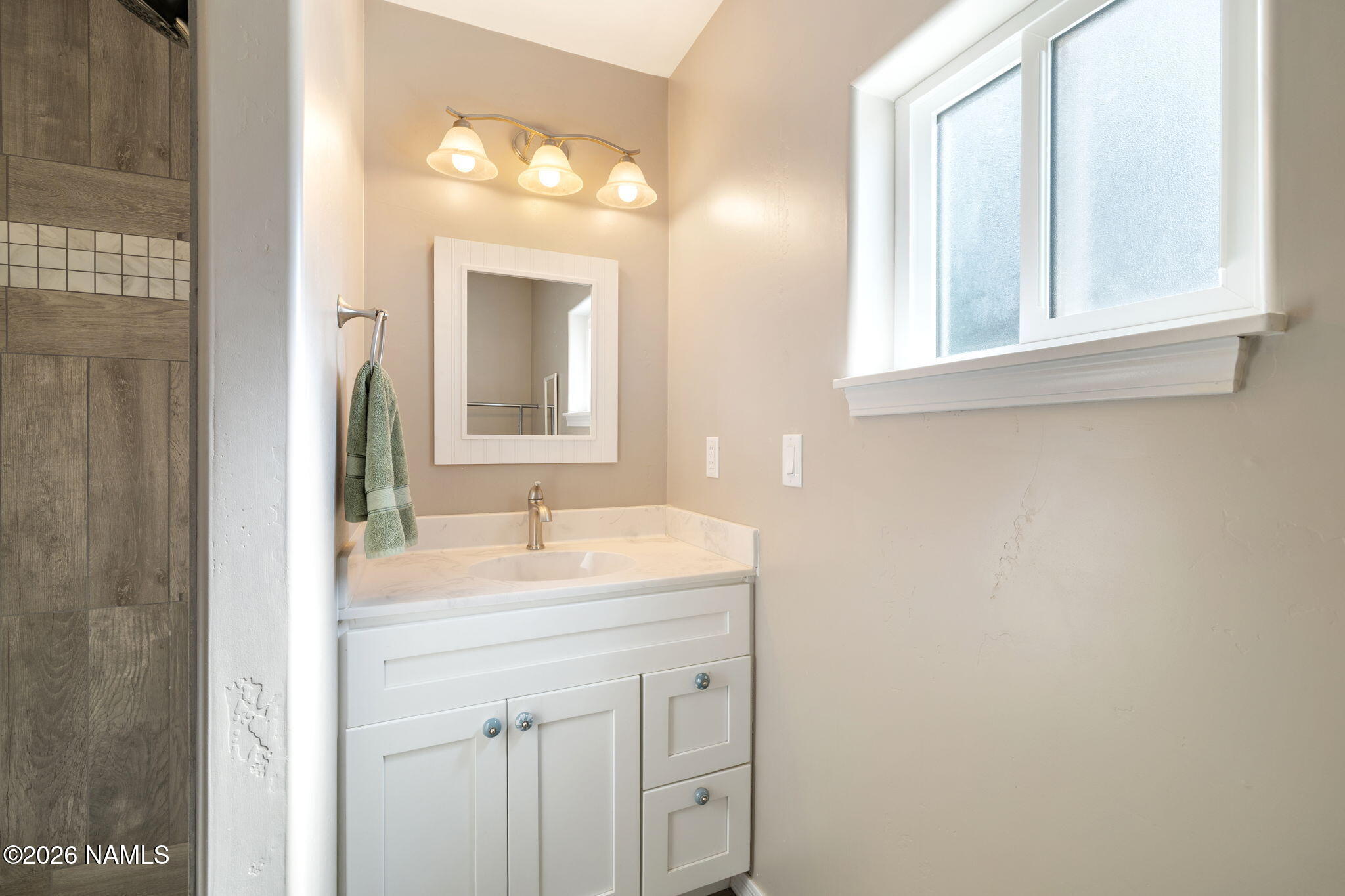 6339 North Bluefield Road Flagstaff, AZ 86004 - Photo 19 of 35 a bathroom with a sink and a mirror
