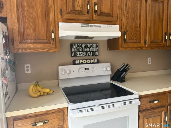 a view of a stove top oven sitting inside of a kitchen
