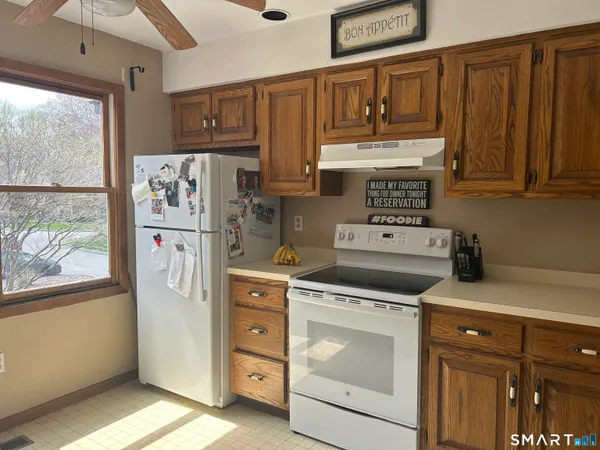 a kitchen with stainless steel appliances white cabinets and a refrigerator