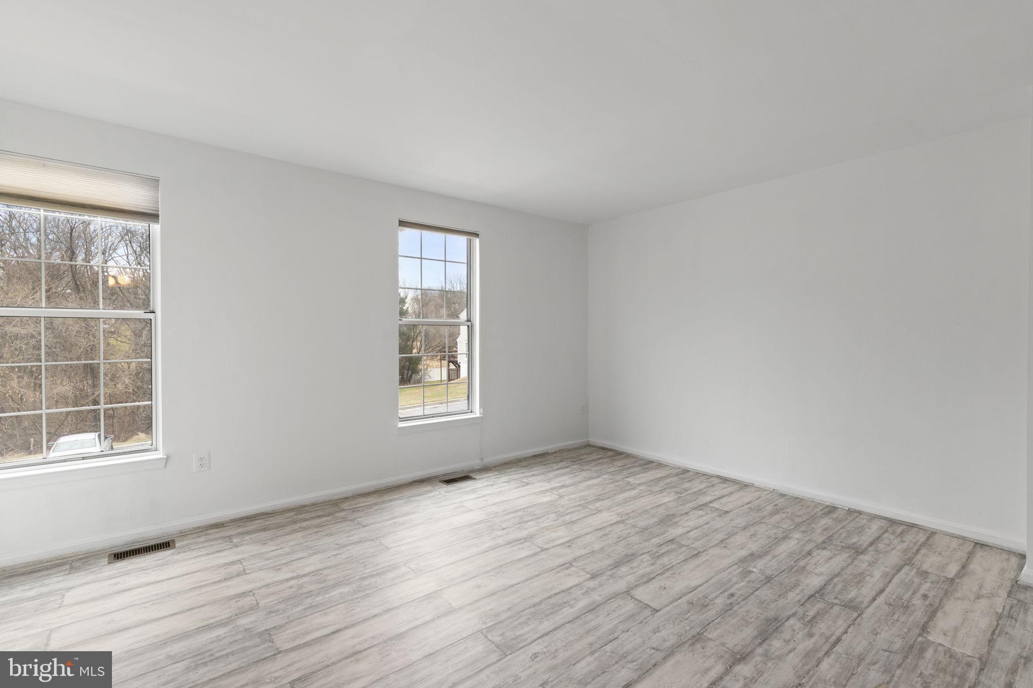 126 Gentlebrook Road Owings Mills, MD 21117 - Photo 19 of 30 an empty room with wooden floor and windows