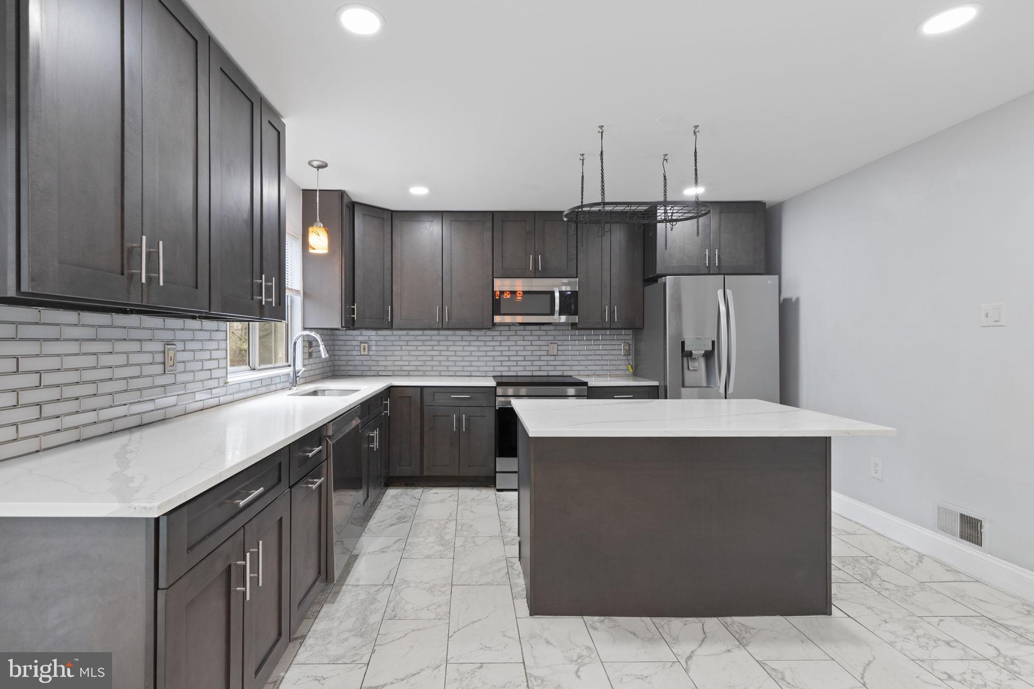 126 Gentlebrook Road Owings Mills, MD 21117 - Photo 5 of 30 a large kitchen with cabinets and stainless steel appliances