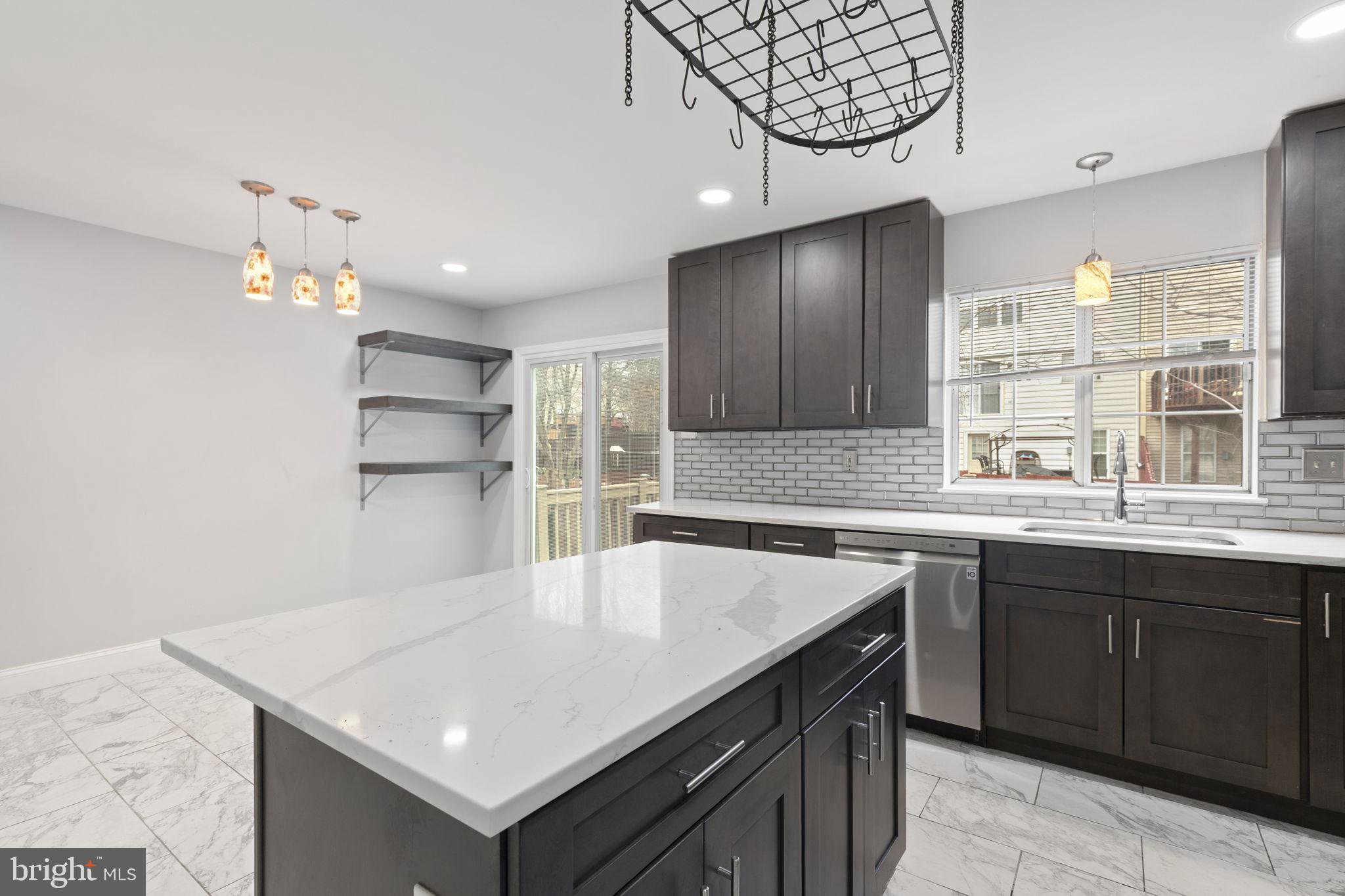 126 Gentlebrook Road Owings Mills, MD 21117 - Photo 7 of 30 a kitchen with kitchen island a sink counter top space and cabinets