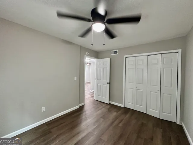 a view of an empty room and wooden floor