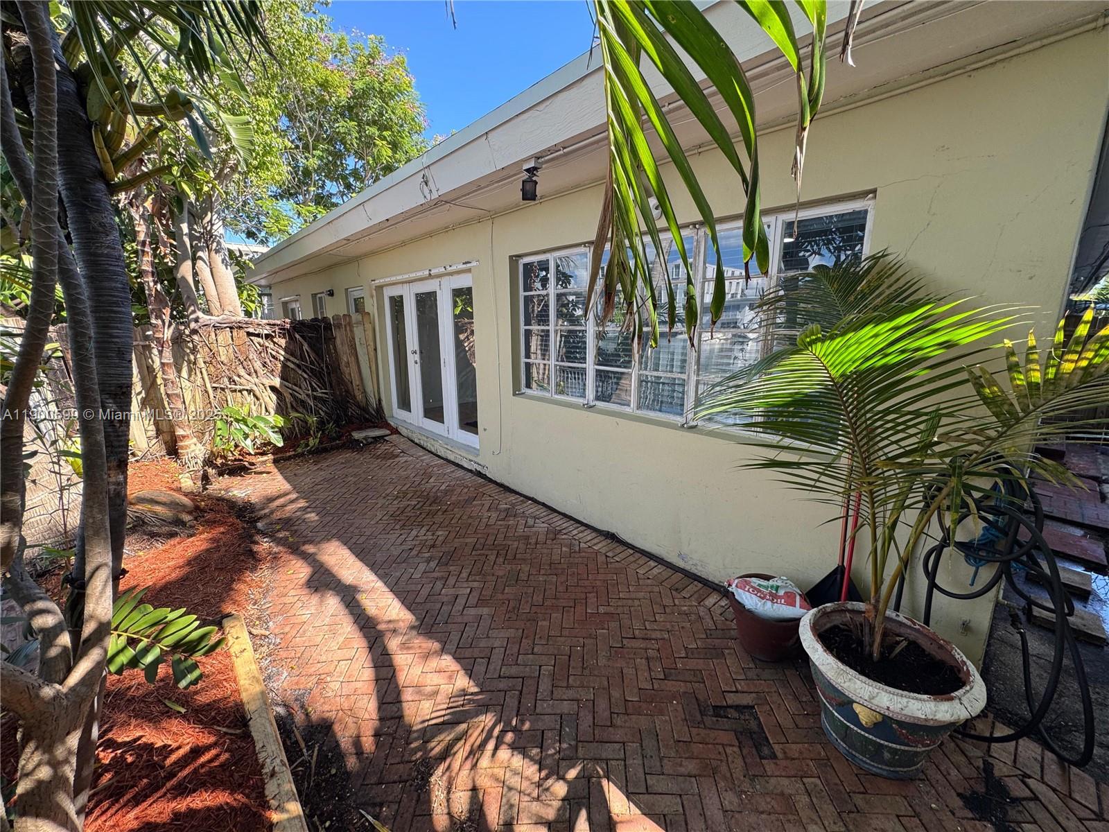 8300 Byron Avenue, Unit 5 Miami Beach, FL 33141 - Photo 11 of 12 a backyard of a house with seating space