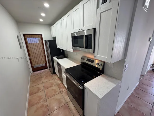 a kitchen with a stove and a microwave