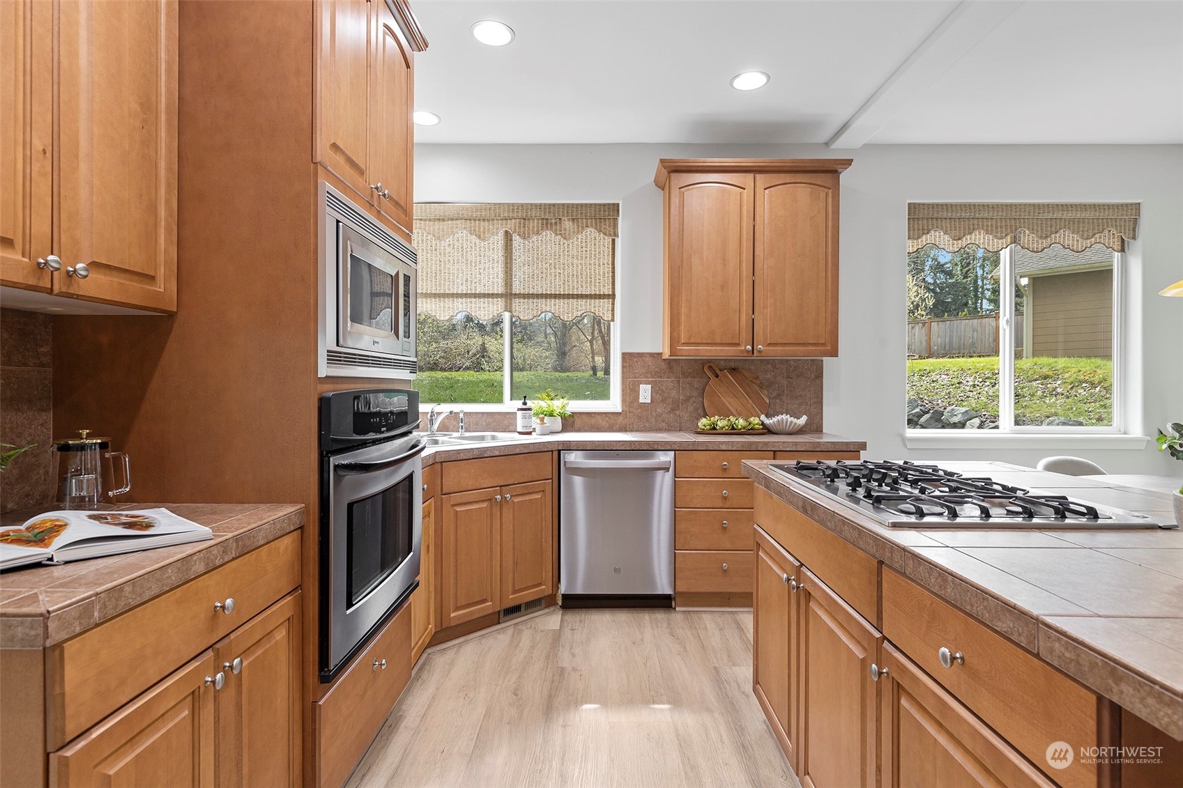 202 199th Street Southwest Bothell, WA 98012 - Photo 11 of 30 a kitchen with stainless steel appliances kitchen island granite countertop a stove a sink and a refrigerator