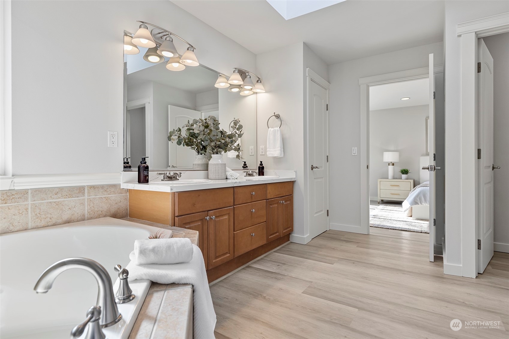 202 199th Street Southwest Bothell, WA 98012 - Photo 22 of 30 a en suite bathroom with a granite countertop sink a mirror and a vanity