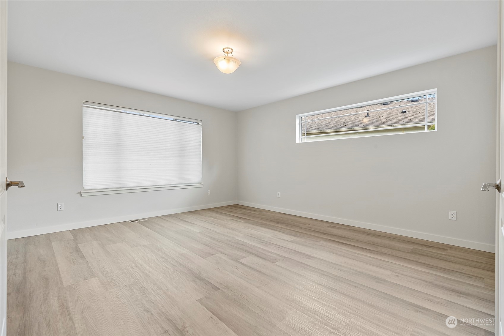 202 199th Street Southwest Bothell, WA 98012 - Photo 24 of 30 an empty room with wooden floor and windows