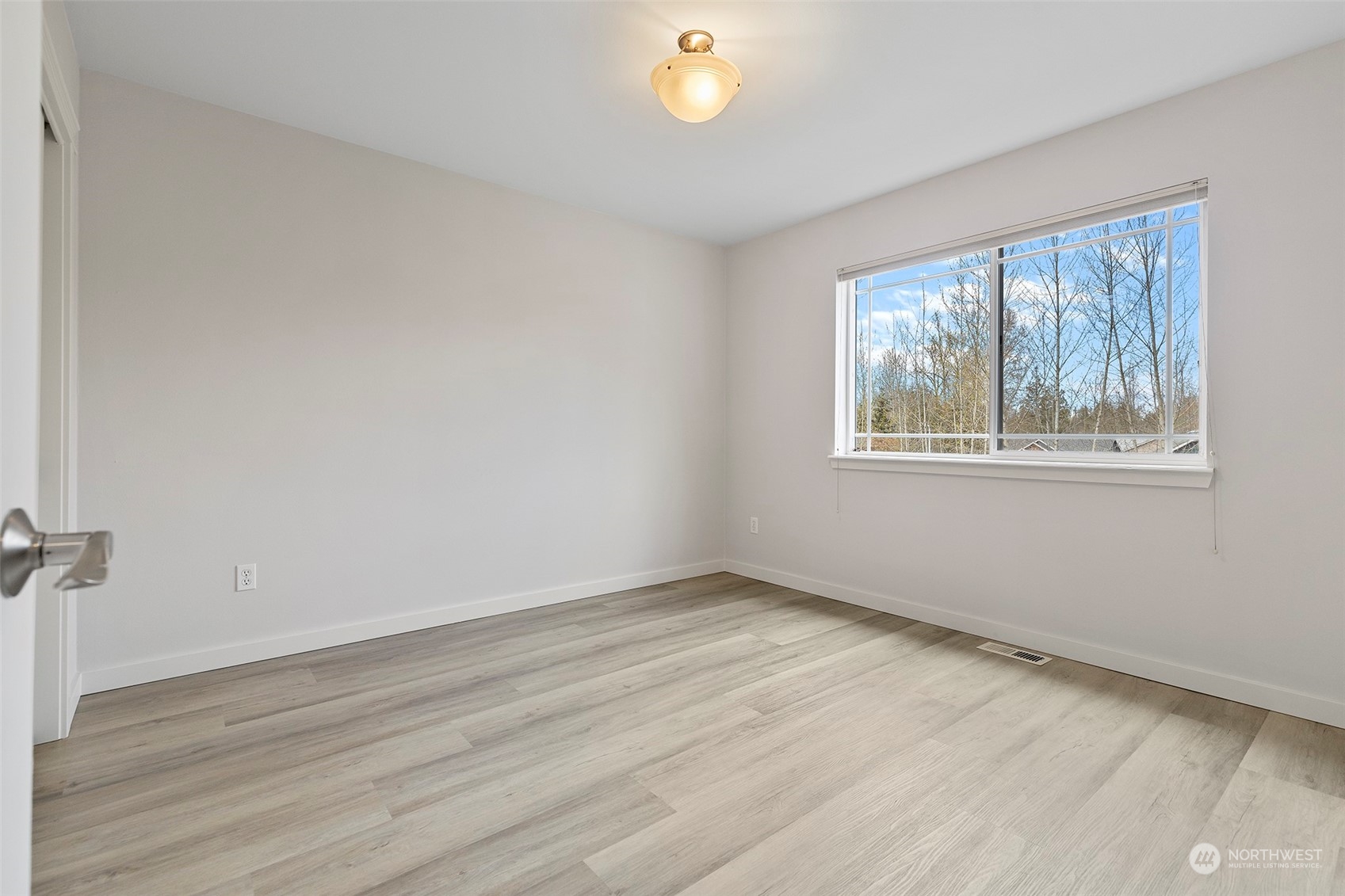 202 199th Street Southwest Bothell, WA 98012 - Photo 26 of 30 a view of an empty room with wooden floor and a window