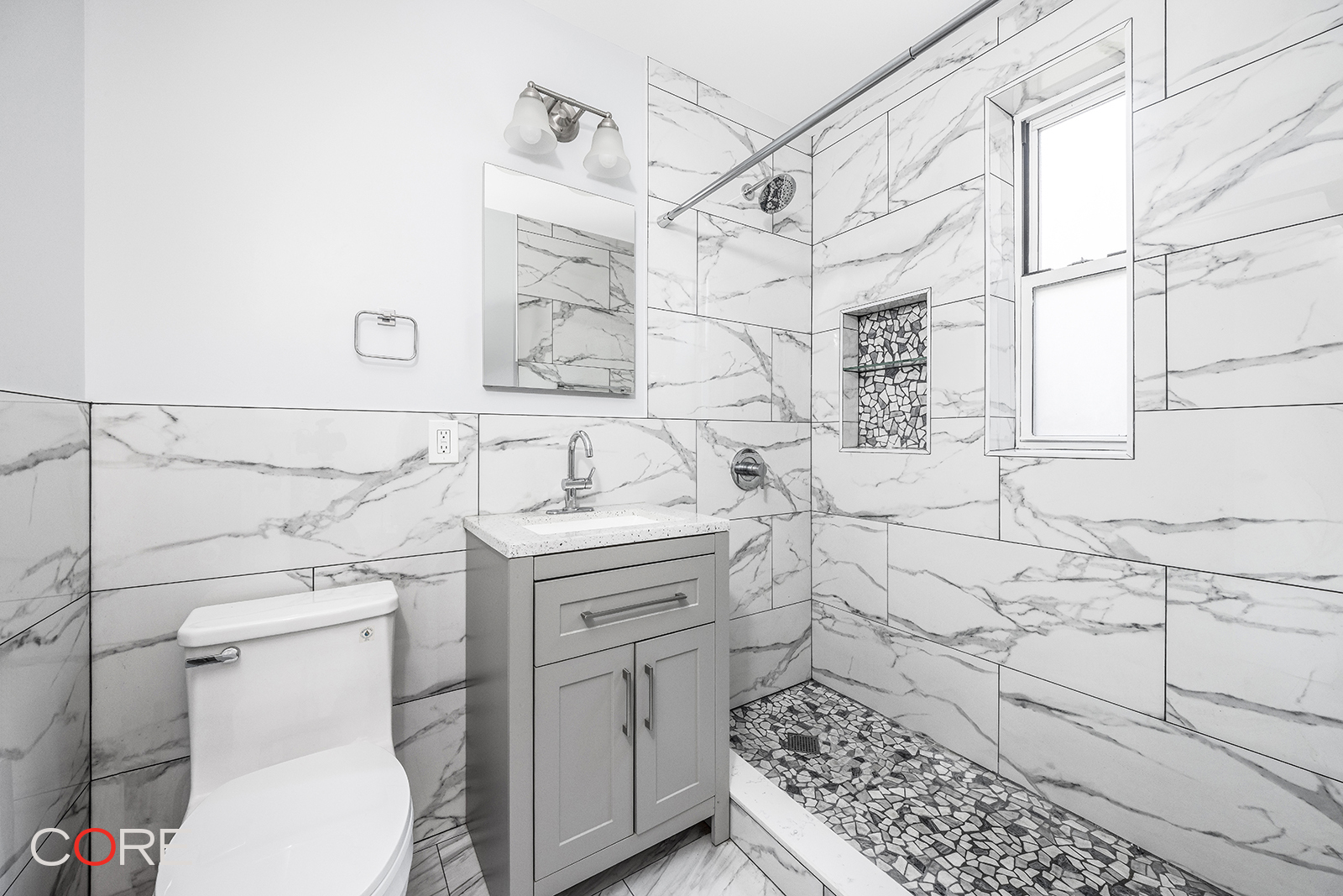 35-21 79th Street, Unit 1L Queens, NY 11372 - Photo 4 of 8 a bathroom with a sink toilet and shower