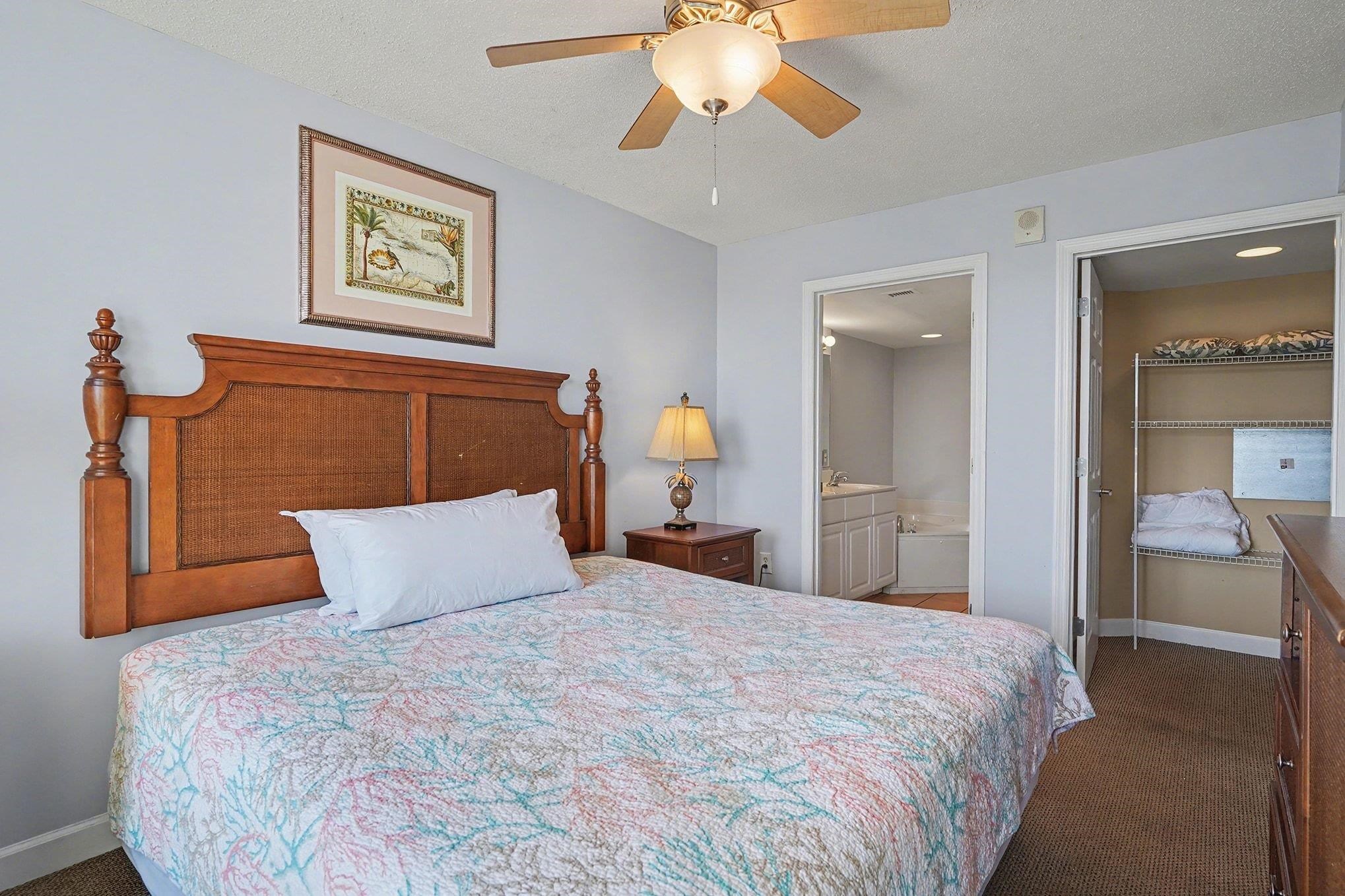 1707 Perrin Drive, Unit 701 North Myrtle Beach, SC 29582 - Photo 15 of 40 Bedroom with dark carpet, a textured ceiling, a ceiling fan, and ensuite bath