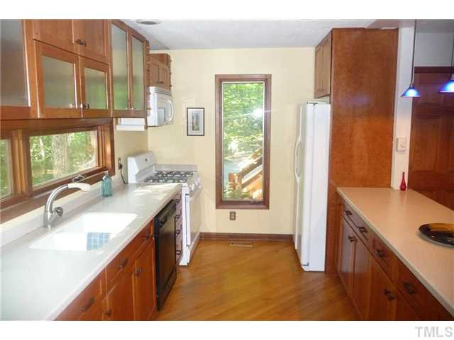 2522 Laine Road Chapel Hill, NC 27516 - Photo 20 of 22 a kitchen with a sink stove and cabinets