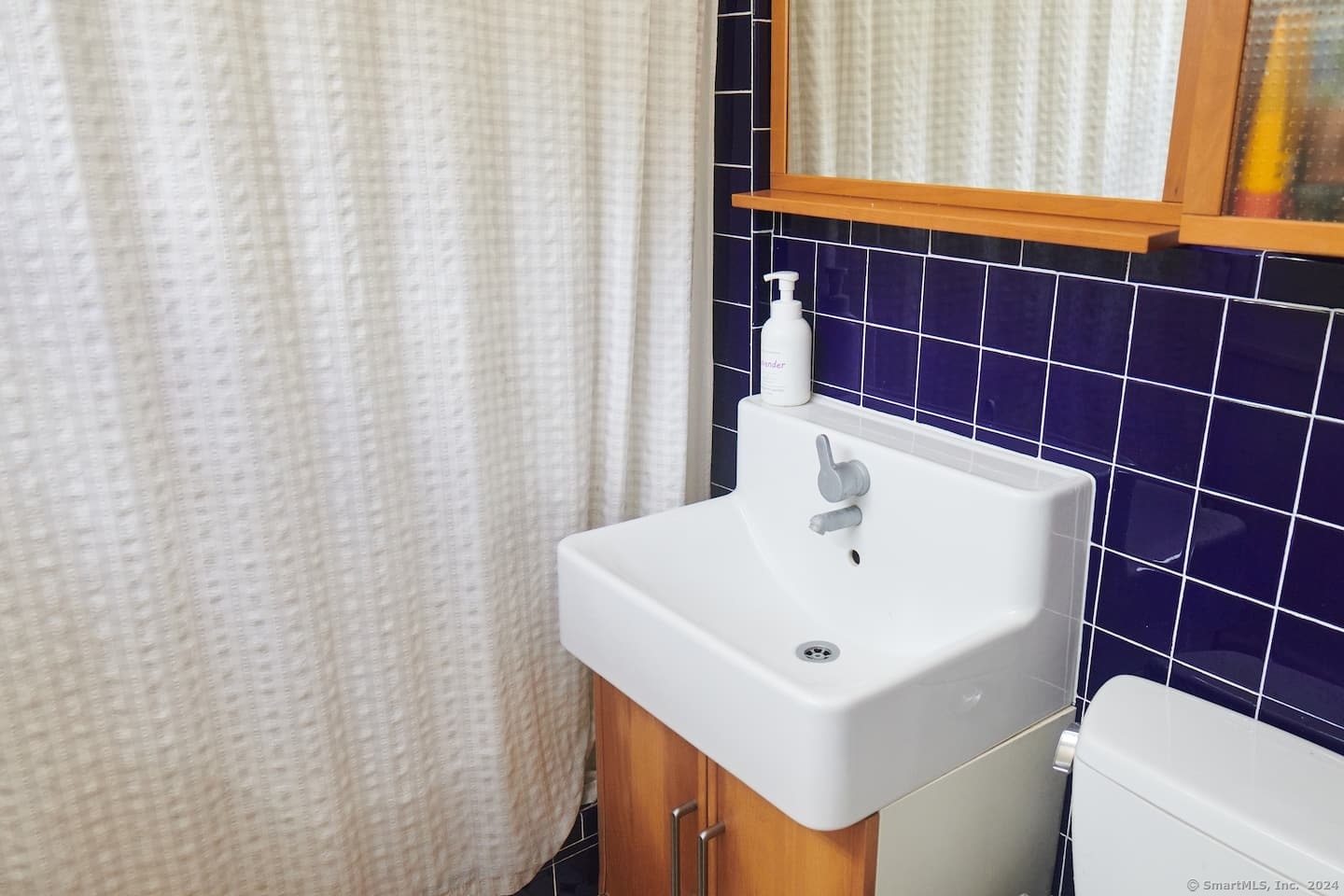433 Segar Mountain Road Kent, CT 06785 - Photo 14 of 15 a bathroom with a sink a toilet and shower curtain