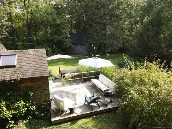 a view of a backyard with plants and patio