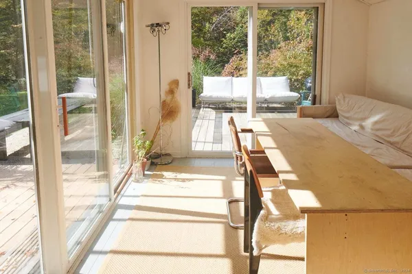 a bedroom with a bed and glass door