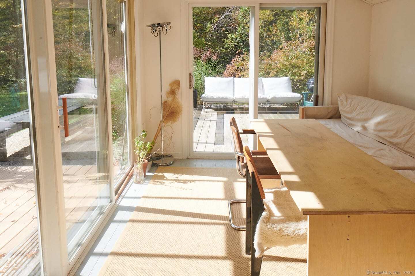 433 Segar Mountain Road Kent, CT 06785 - Photo 7 of 15 a bedroom with a bed and glass door