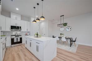 3544 Mt Pleasant Street Houston, TX 77021 - Photo 3 of 12 a large kitchen with stainless steel appliances kitchen island granite countertop a sink and cabinets