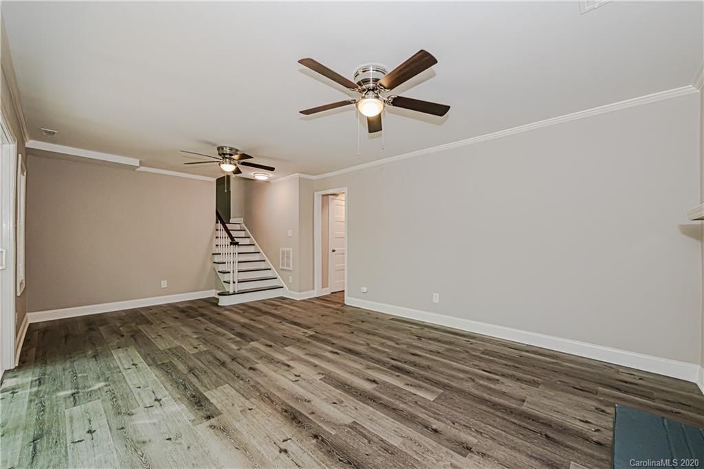 7415 Watercrest Road Charlotte, NC 28210 - Photo 22 of 35 a view of empty room with wooden floor and ceiling fan