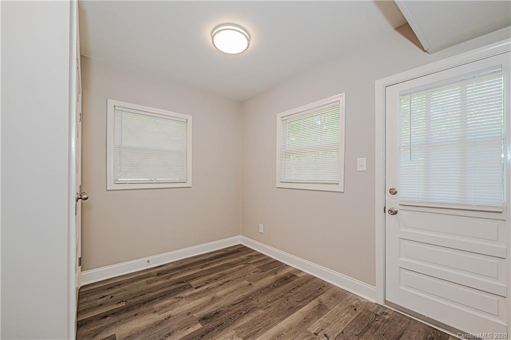 7415 Watercrest Road Charlotte, NC 28210 - Photo 23 of 35 a view of an empty room with wooden floor and a window