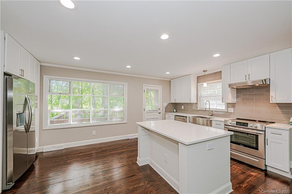 7415 Watercrest Road Charlotte, NC 28210 - Photo 4 of 35 a kitchen with a stove a sink and a refrigerator