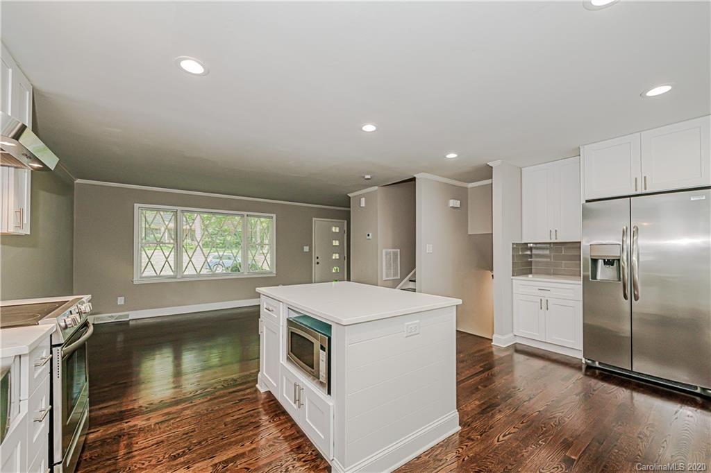 7415 Watercrest Road Charlotte, NC 28210 - Photo 5 of 35 a kitchen with a refrigerator a sink and a stove top oven