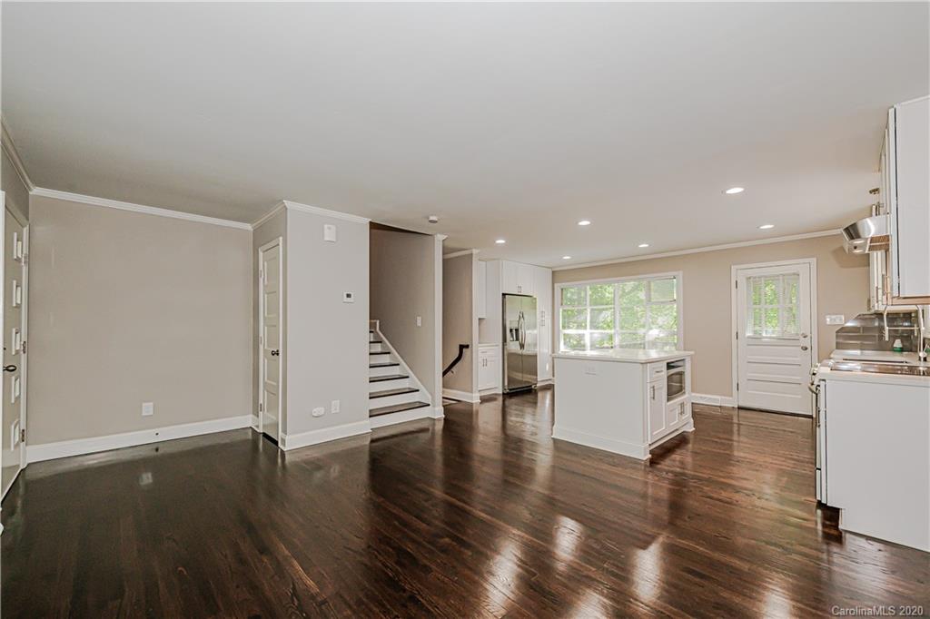 7415 Watercrest Road Charlotte, NC 28210 - Photo 8 of 35 a view of an empty room with wooden floor and a window