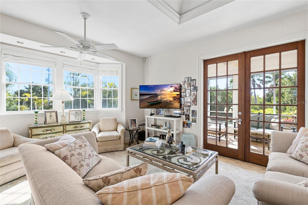 162 Blackwall Court Boca Grande, FL 33921 - Photo 11 of 62 a living room with furniture a flat screen tv and a large window