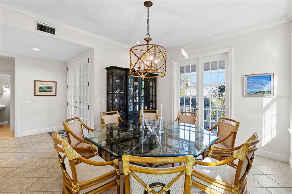 162 Blackwall Court Boca Grande, FL 33921 - Photo 19 of 62 a dining room with furniture a chandelier and wooden floor
