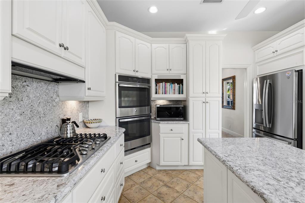 162 Blackwall Court Boca Grande, FL 33921 - Photo 22 of 62 a kitchen with white cabinets and appliances