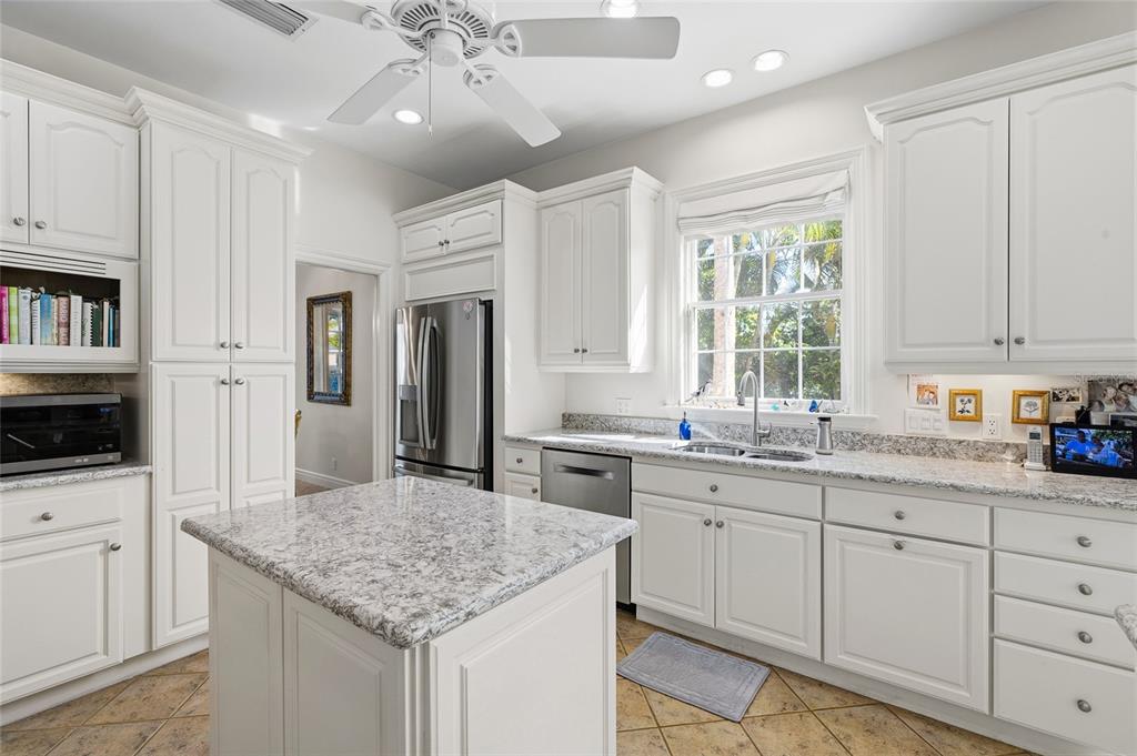 162 Blackwall Court Boca Grande, FL 33921 - Photo 23 of 62 a kitchen with stainless steel appliances granite countertop a sink stove and refrigerator