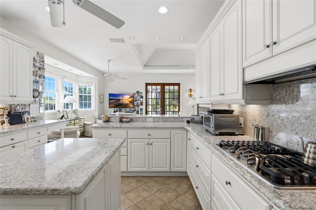 162 Blackwall Court Boca Grande, FL 33921 - Photo 24 of 62 a kitchen with stainless steel appliances granite countertop a sink stove and cabinets