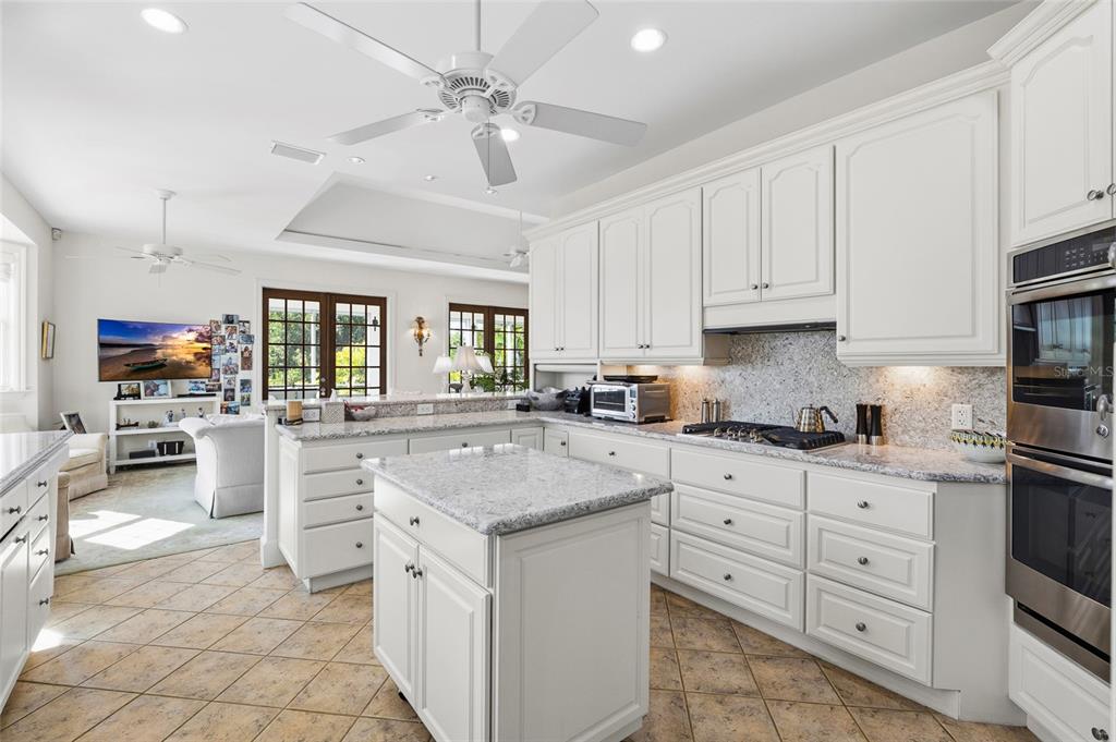 162 Blackwall Court Boca Grande, FL 33921 - Photo 25 of 62 a kitchen with white cabinets and appliances
