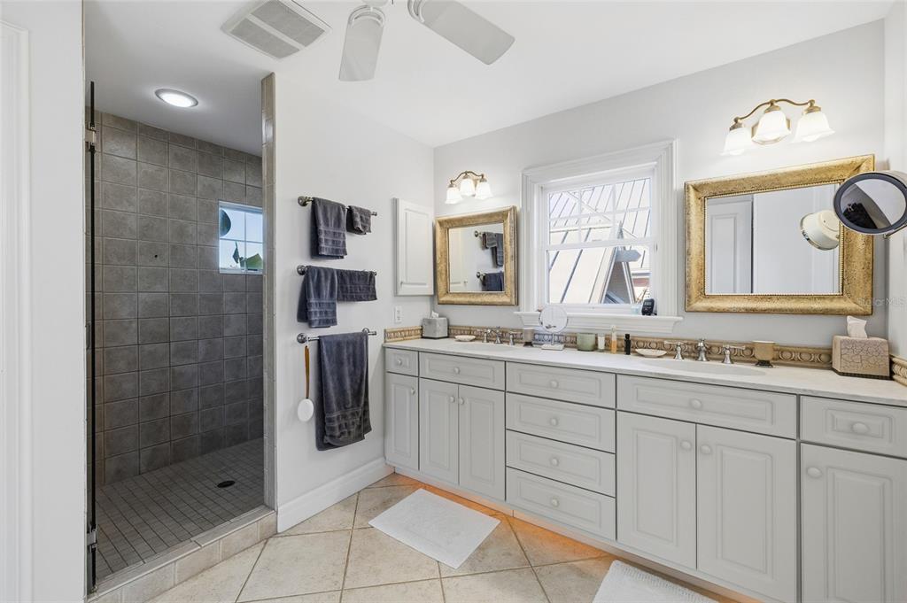 162 Blackwall Court Boca Grande, FL 33921 - Photo 31 of 62 a spacious bathroom with a shower sink and mirror