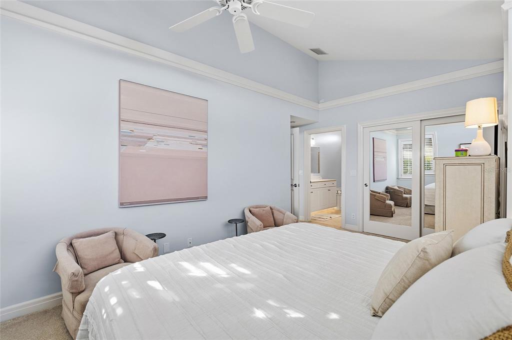 162 Blackwall Court Boca Grande, FL 33921 - Photo 38 of 62 a bedroom with a large bed and a chandelier