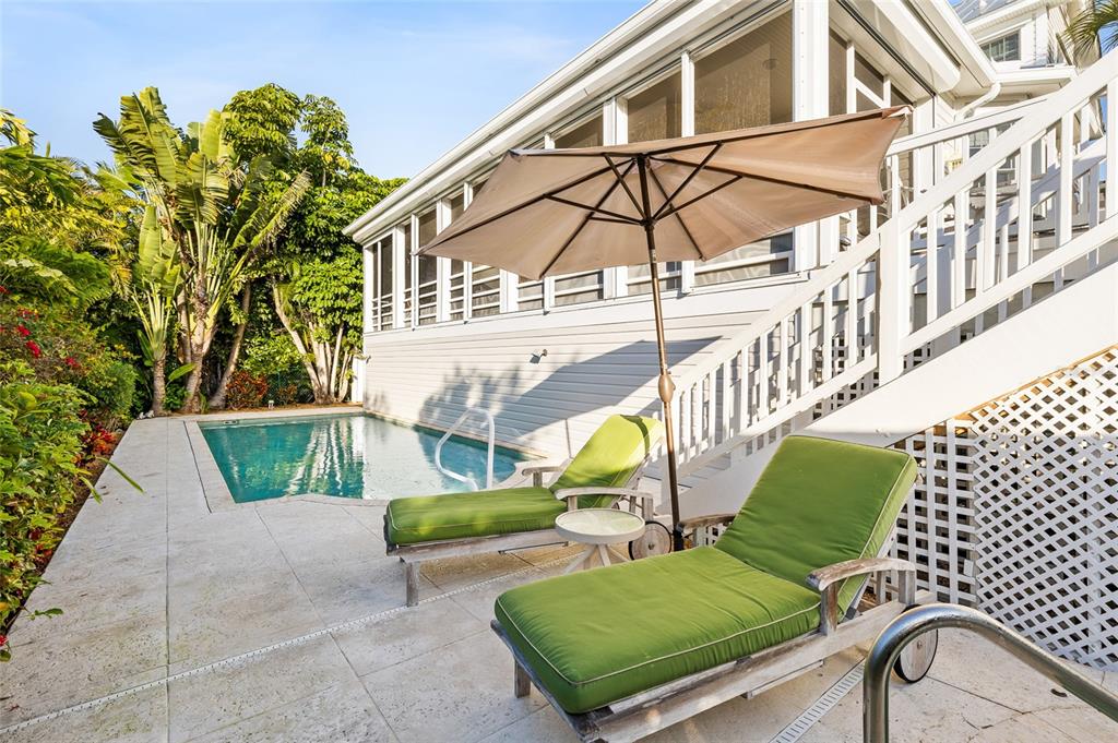 162 Blackwall Court Boca Grande, FL 33921 - Photo 43 of 62 a view of an chairs and tables in the back yard