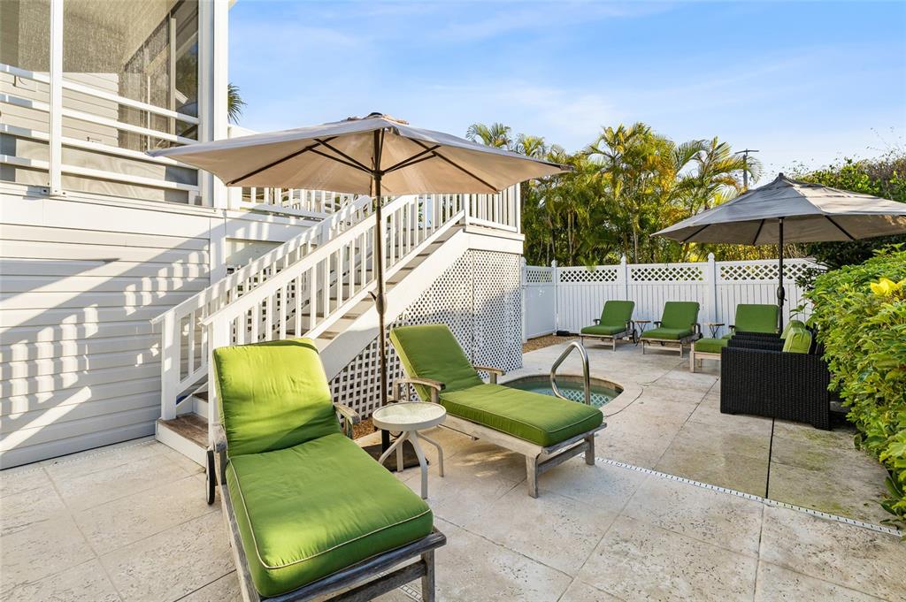 162 Blackwall Court Boca Grande, FL 33921 - Photo 47 of 62 a view of a patio with couches and a table and chairs under an umbrella