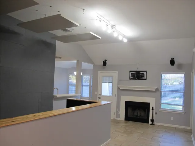 a view of a livingroom with a fireplace and window