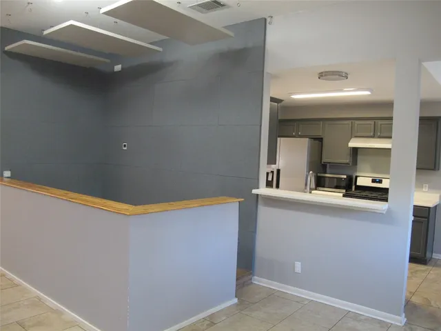a kitchen with stainless steel appliances granite countertop a sink and cabinets