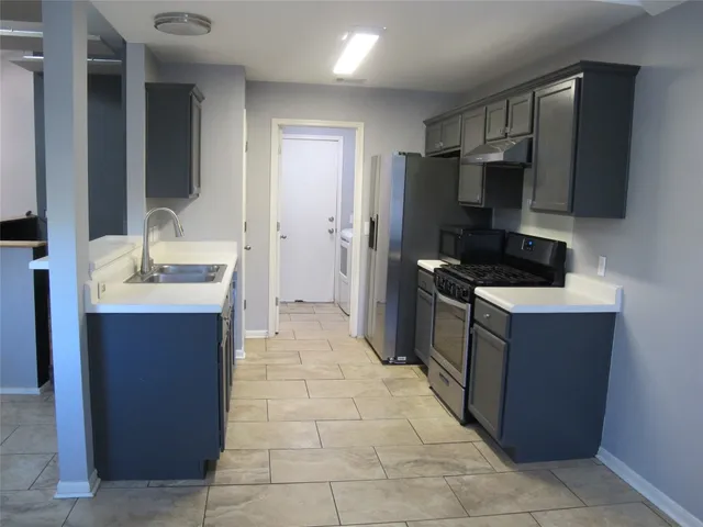a kitchen with stainless steel appliances a refrigerator and a sink