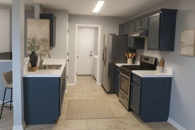 a kitchen with a sink counter top space a refrigerator and a sink