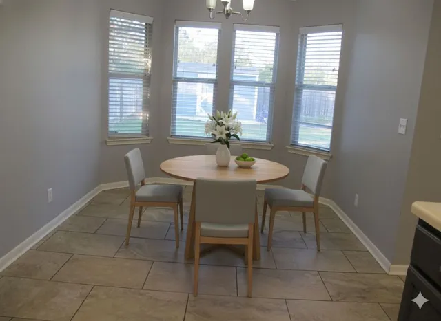 a dining room with furniture and window