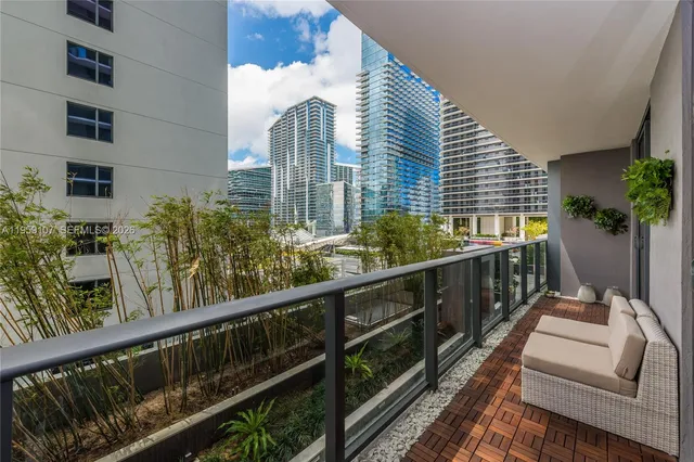 a view of balcony with a large window and potted plant