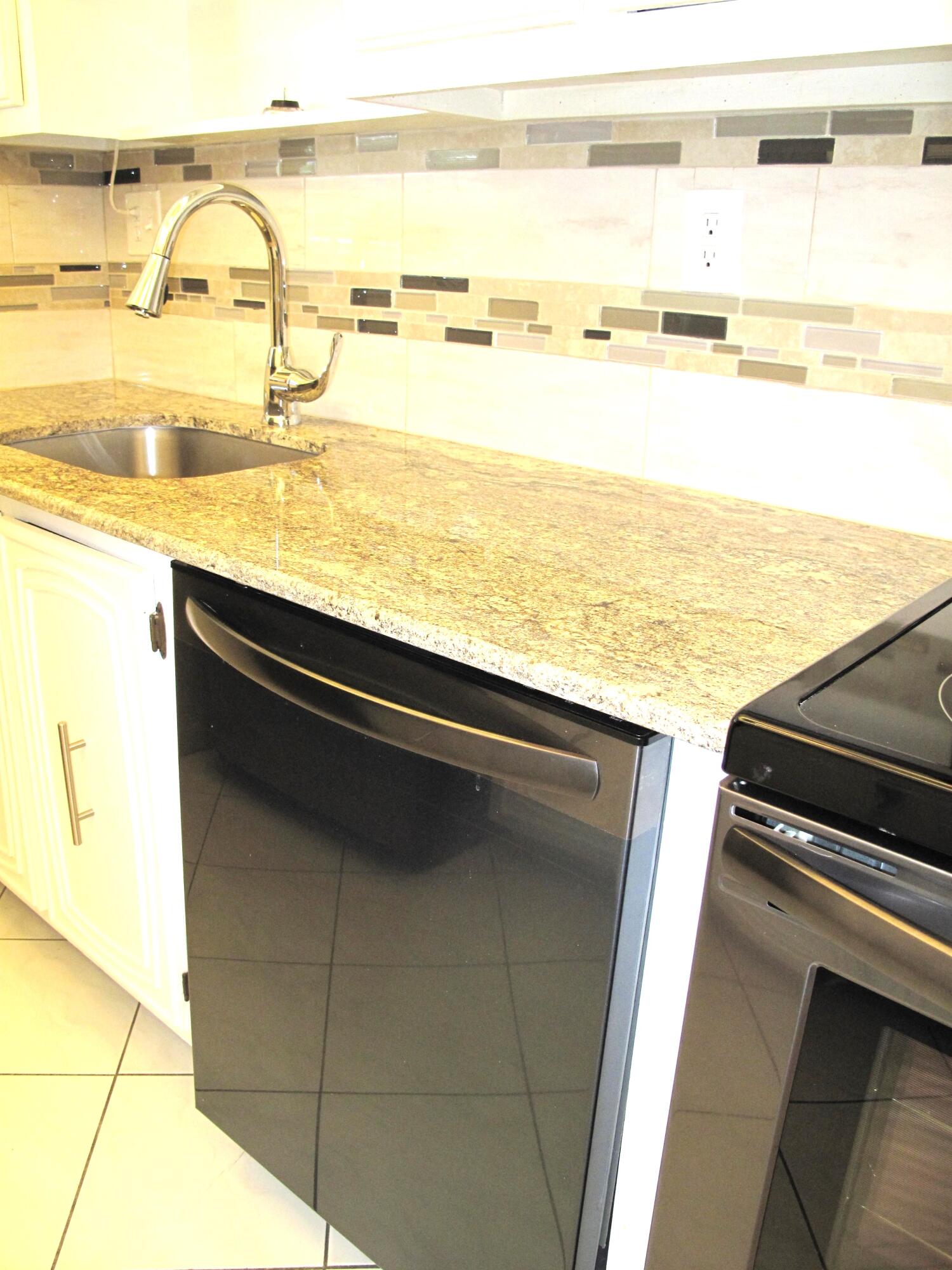 1202 South Drive Circle, Unit B Delray Beach, FL 33445 - Photo 17 of 57 New Black SS appliances with new garnite