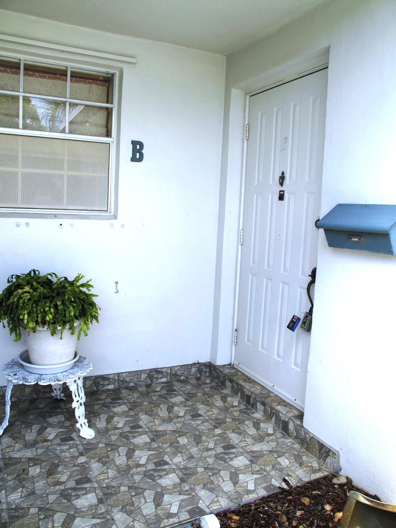 1202 South Drive Circle, Unit B Delray Beach, FL 33445 - Photo 2 of 57 Non skid tile entrance to villa