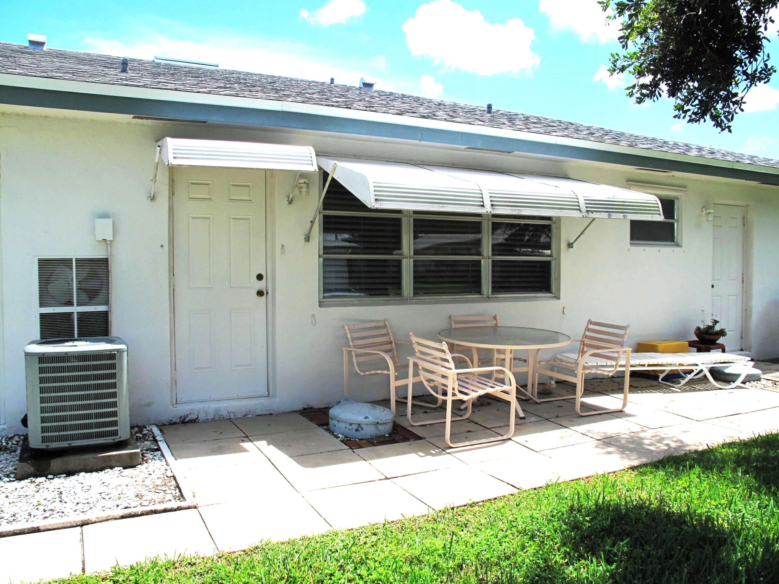 1202 South Drive Circle, Unit B Delray Beach, FL 33445 - Photo 36 of 57 Rear view of villa with patio