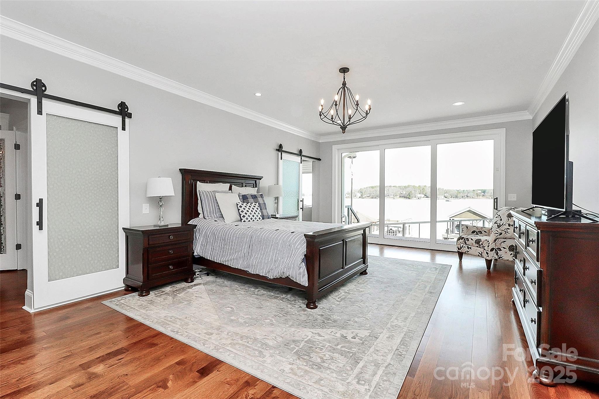 5086 Windward Point Lane Denver, NC 28037 - Photo 16 of 36 a spacious bedroom with a large bed and a flat tv screen on a dresser