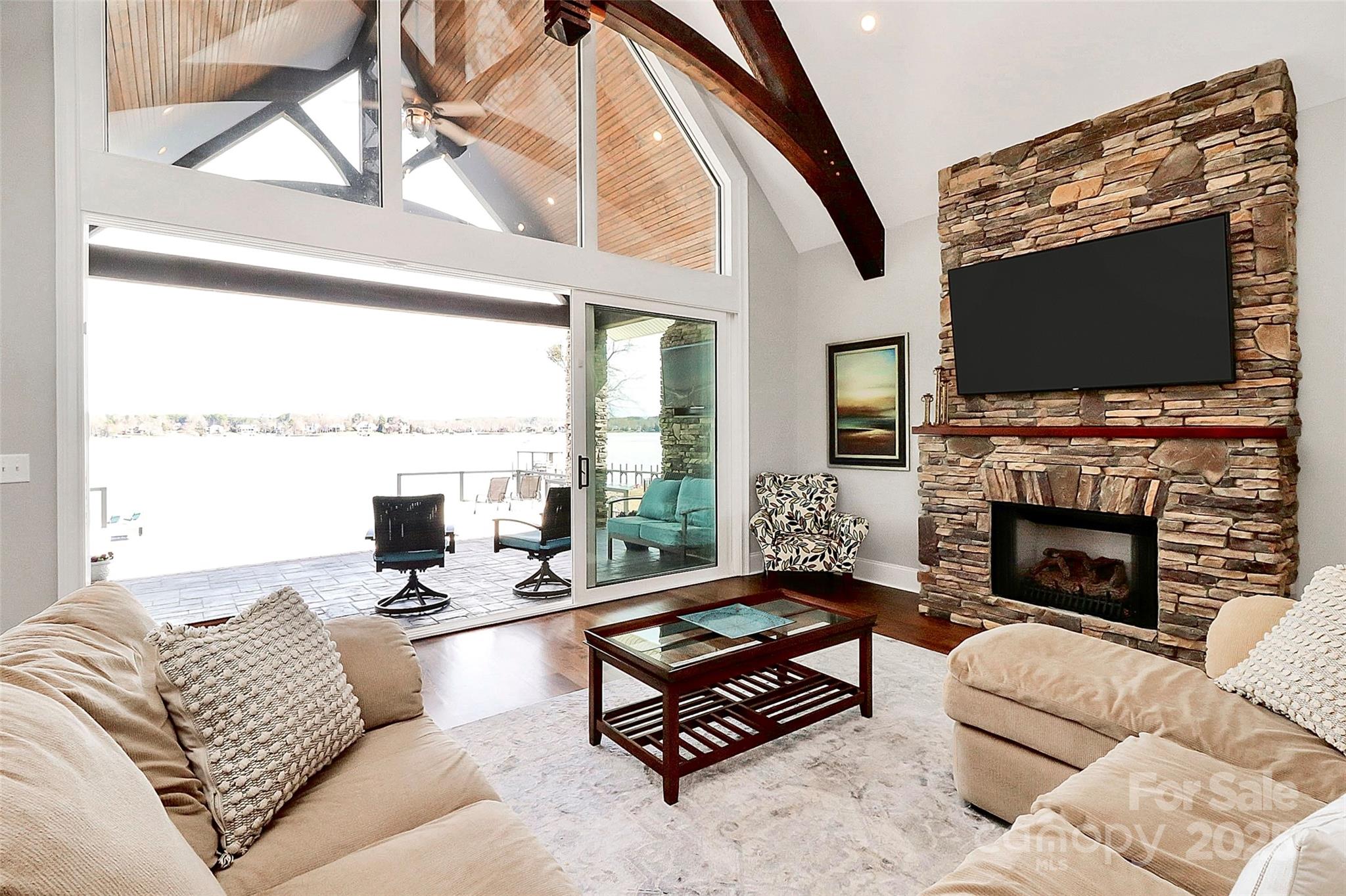 5086 Windward Point Lane Denver, NC 28037 - Photo 3 of 36 a living room with furniture fireplace and a flat screen tv
