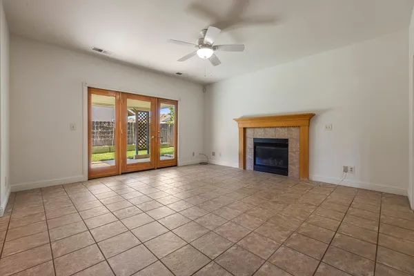 a view of a livingroom with an empty space and a fireplace