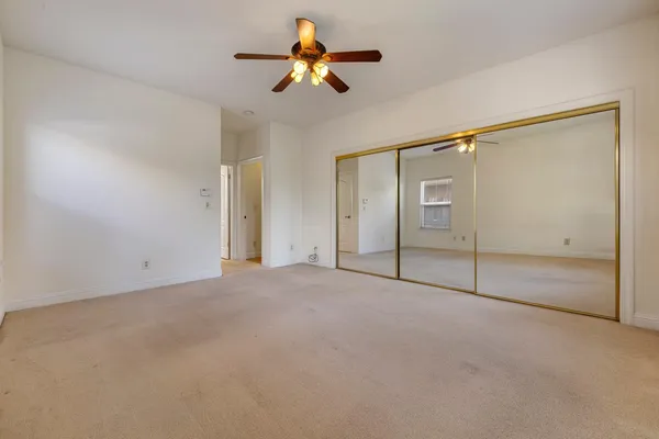 an empty room with windows and pillars in it