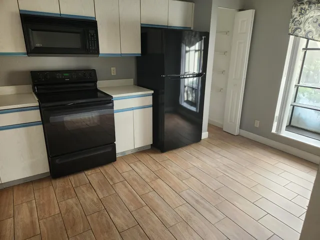 a kitchen with stainless steel appliances a refrigerator and a stove top oven